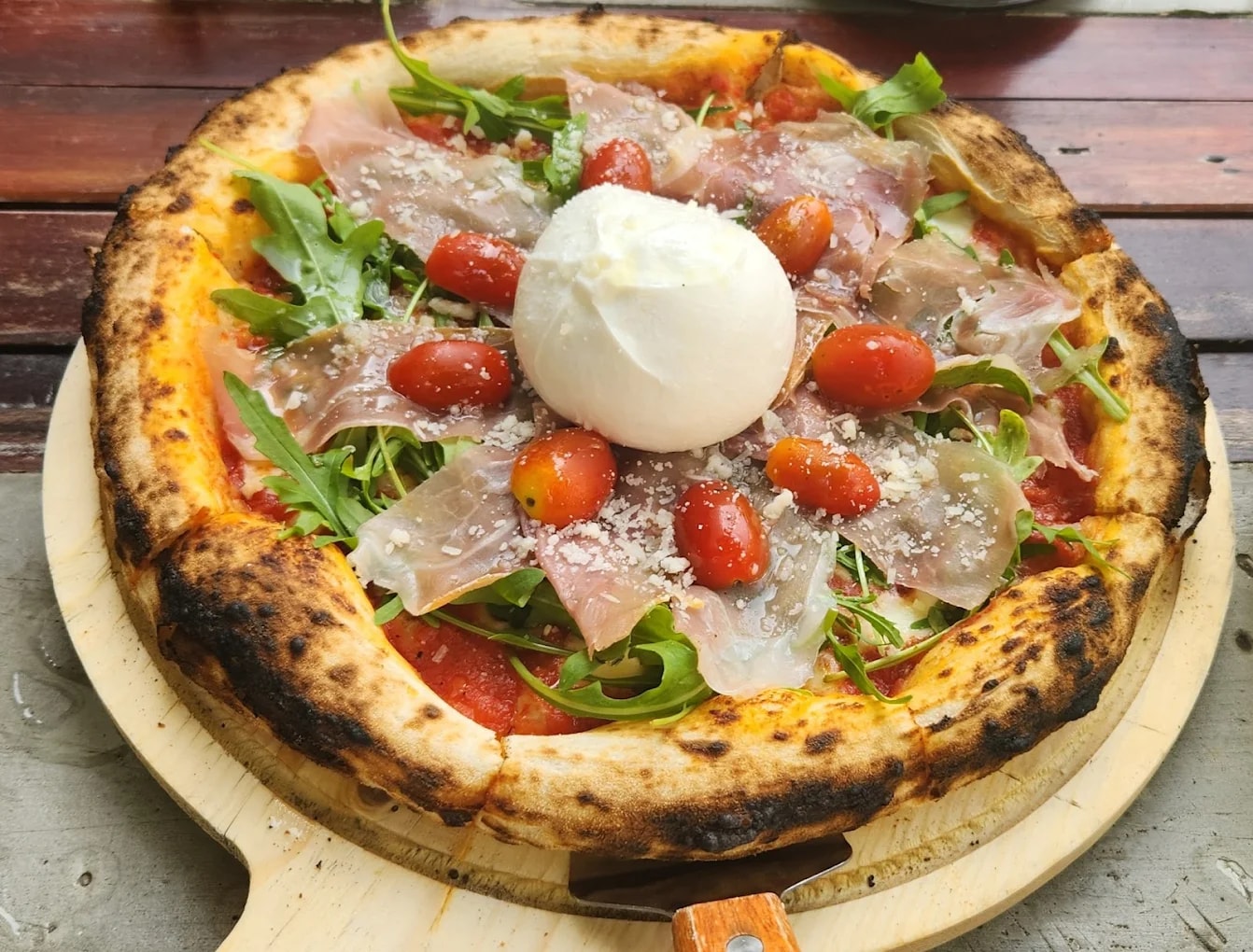 Their pizza stands out with a thin base, creamy cheese, and vibrant homemade tomato sauce